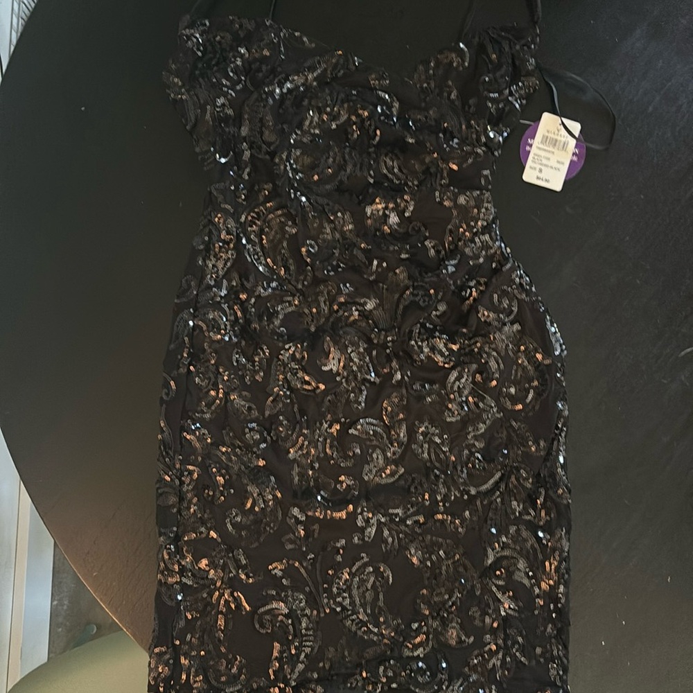 Black cross crossed front, zip in back, sparkly beaded design!